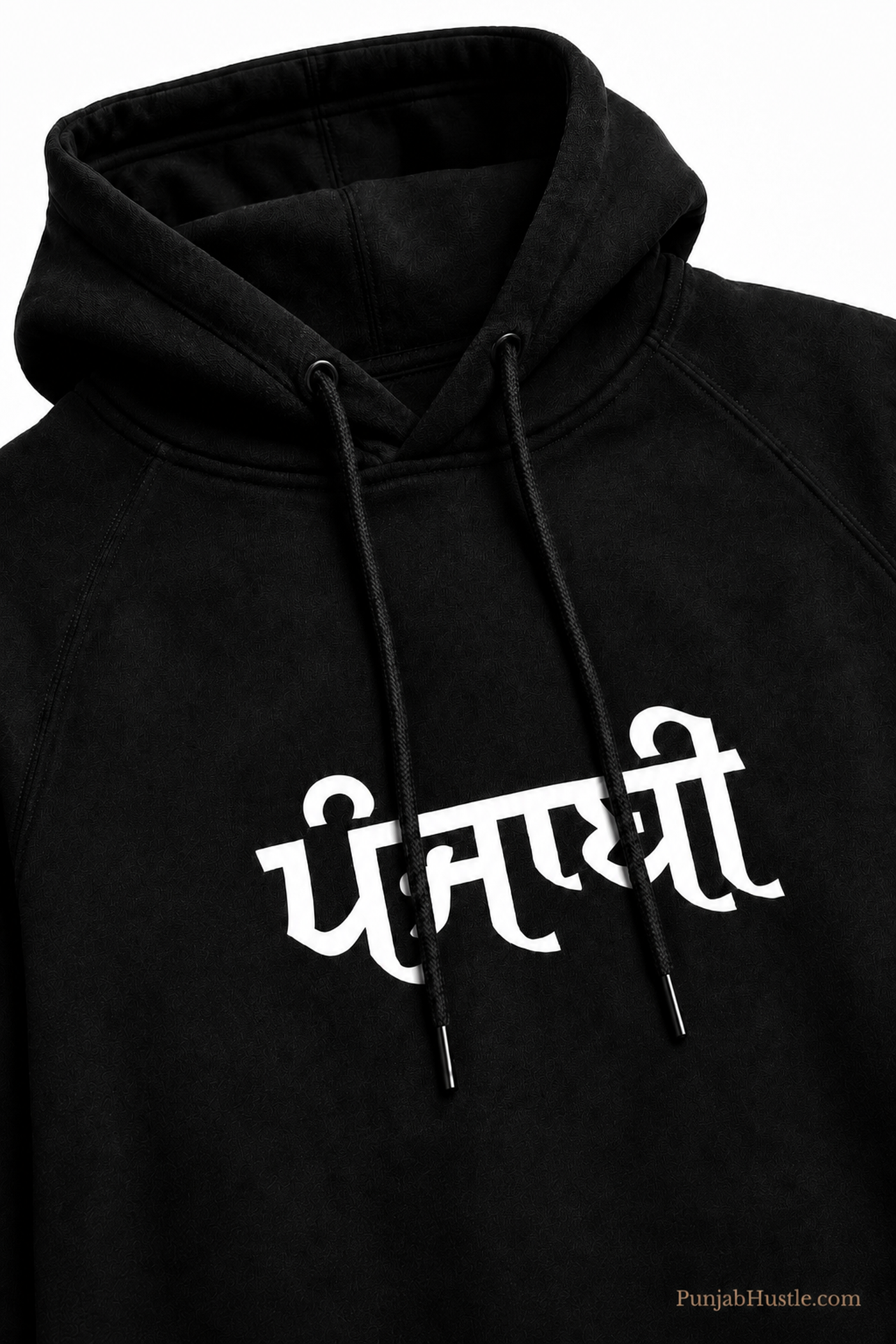 Close-up of the white ਪੰਜਾਬੀ chest print, drawstrings, hood and fabric texture on a black hoodie.
